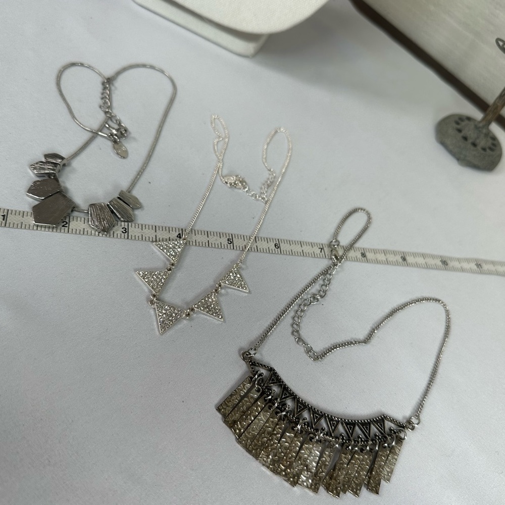 Three flag style silvertone necklaces